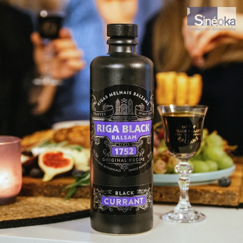 Baume de Riga au cassis sur une table avec 1 verre